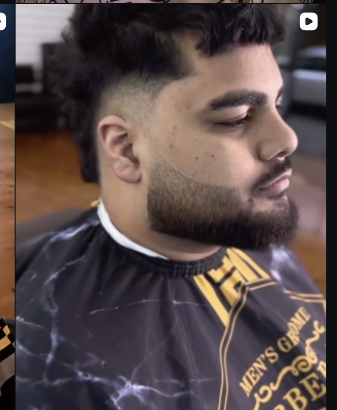 Skin fade blended into a full beard trim
