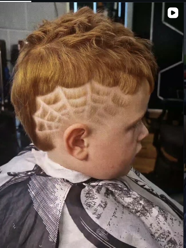 Spiderweb design razored into a young client's haircut