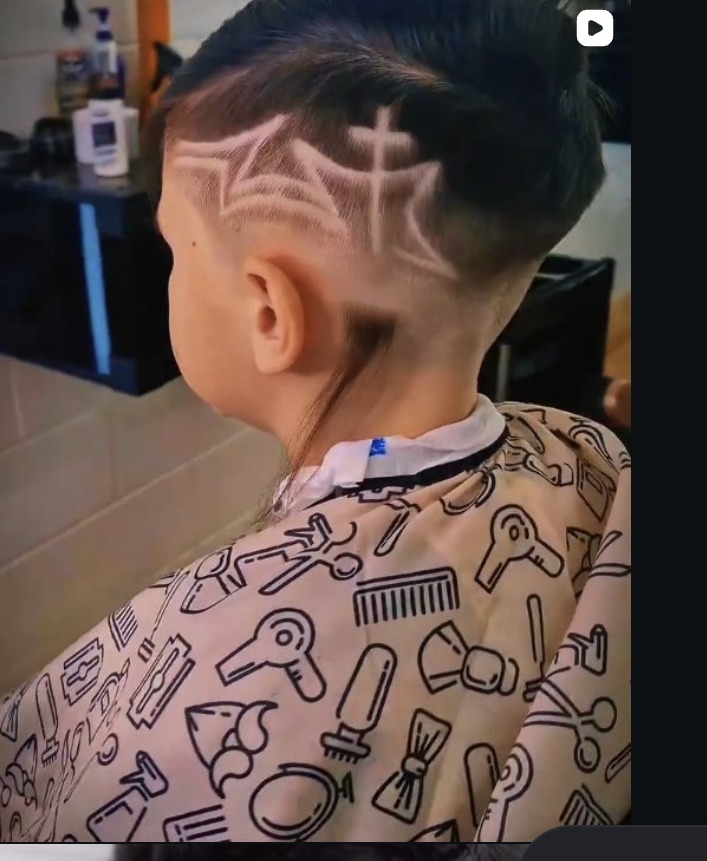 Freehand web design razored into the back of a haircut